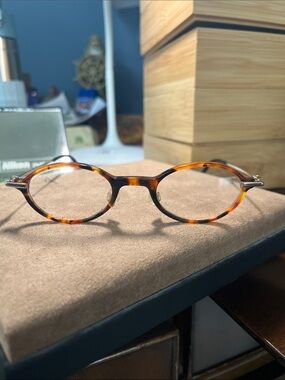 Otto Kern eyeglasses with oval tortoise frame, gold temple tips and temples.